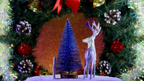 Deer snowflake and fir tree rotate on the background of a Christmas wreath Video stock 284205486