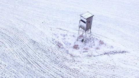 Deer-stand or watch tower for hunting of boars in snowy fields. Stock-Footage 101071233