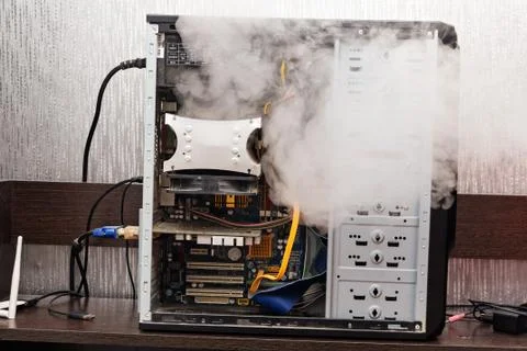 A defective personal computer started to smoke. Fotos de archivo