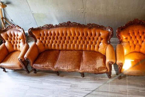 Defects on a leather sofa. Damaged to leather furniture. Stock Photos