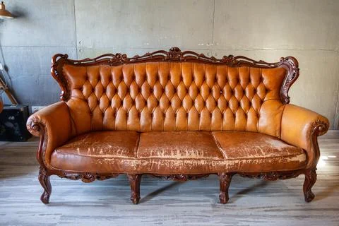 Defects on a leather sofa. Damaged to leather furniture. Stock Photos