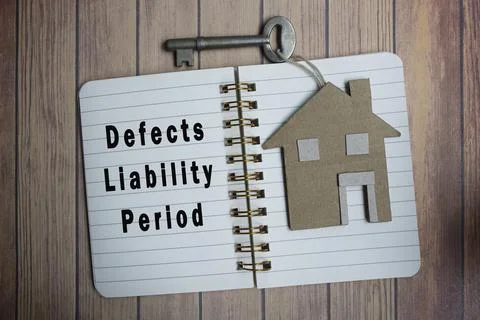 Defects liability period text on notepad with house model and key on wooden d Stock Photos