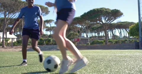 Defender approaching, two teens are exchanging close dribbles and tackles on Stock Footage 345035967