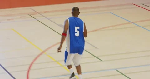 Defender guarding male dribbling crossover on court hesitating and sprinting Stock Footage 345213599