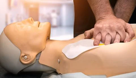 Defibrillator AED CPR emergency first aid training demonstration Fotos Stock