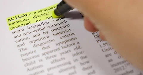 The definition of Autism being emphasized by a yellow marker Stock Footage 50928391