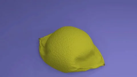 A deflated abstract yellow ball in the form of a lemon Stock Footage 196323768