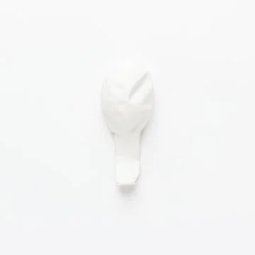 Deflated balloon on the white background Stock Photos