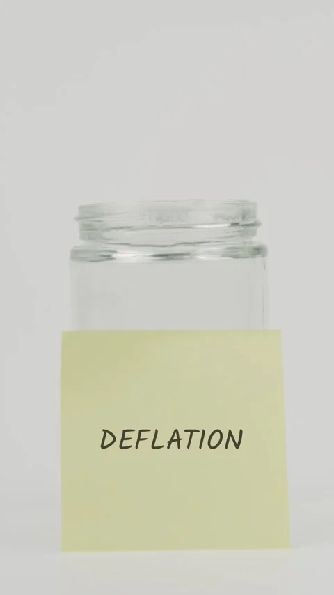 Deflation text or word on yellow sticky note attached to glass jar with hand Stock Footage 311712068
