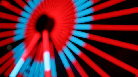 Defocsued blue and red light show on a ferris wheel at night Stock Footage 120138184