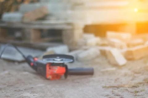 Defocus angle grinder. Tool for construction industry. Copy space. Constructi Stock Photos