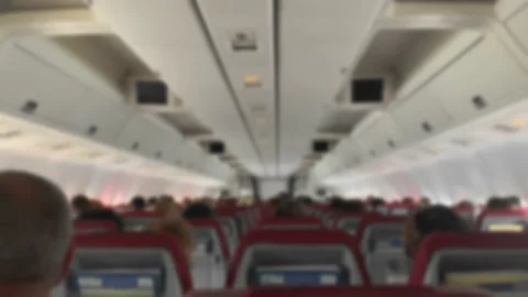 Defocus Back view of interior and people passengers are sitting on plane during Stock Footage 155011122