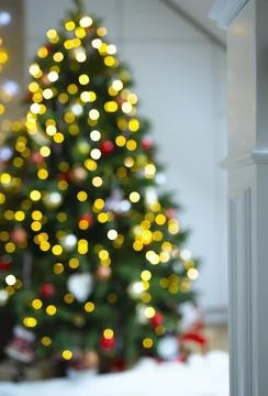 Defocus background, blurred spruce with lights, highlights and gifts under the Stock Photos