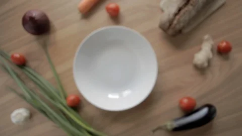 Defocus background shot of hand put on and take off white plate on wooden table 스톡 동영상 115132753