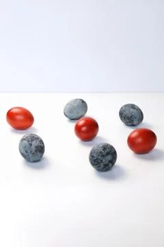 Defocus blue and red eggs on white background. Minimal Easter celebration c.. Stock Photos