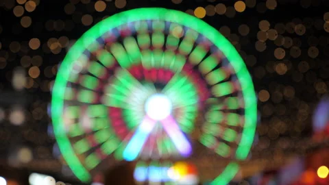 Defocus blur close up festively decorated ferris wheel with glowing garlands Stock Footage 140953638
