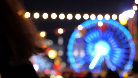 Defocus blur Festively decorated square with glowing garlands Ferris wheel Stock Footage 141113374