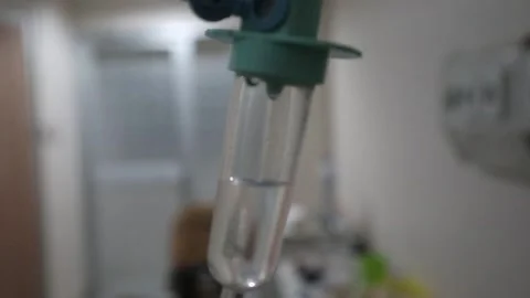 Defocus blur medical IV drip chamber in hospital room. Video stock 341309506