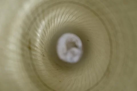 Defocus, blur, noise, grain effect. Inside a roll of white plastic mesh. Buil Stock Photos