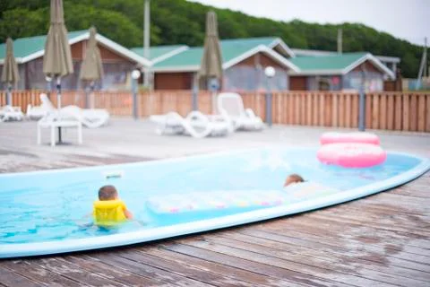 Defocus blurred background recreation base wooden houses pool sunbeds wooden  Stock Photos