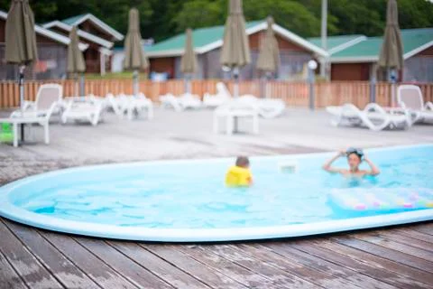 Defocus blurred background recreation base wooden houses pool sunbeds wooden  Stock Photos
