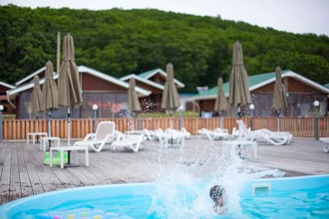 Defocus blurred background recreation base wooden houses pool sunbeds wooden  Stock Photos