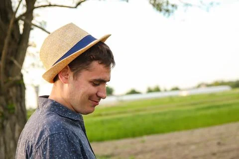 Defocus farmer in hat working on field with greenhouse outdoor. Portrait of.. Stock Photos