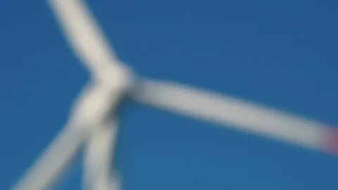 Defocus in focus alternative energy sources. Large rotating wind turbine Stock Footage 91662640