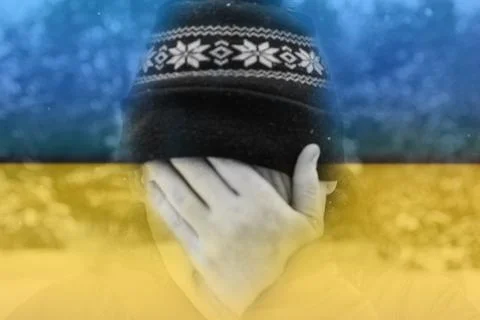 Defocus man hiding face. Flag Ukraine. Increase in the cost of gas bill. Soaring Foto stock