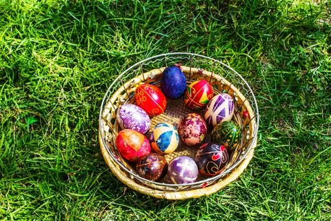 Defocus multicolored easter eggs. Decorated pysanka and krashanka. Wooden Basket Stock Photos