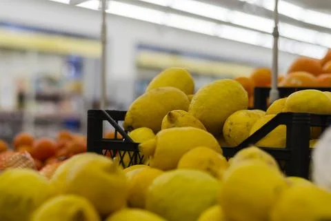 Defocus, noise, selective focus. Close-up of lemon and orange counter at loca Stock Photos