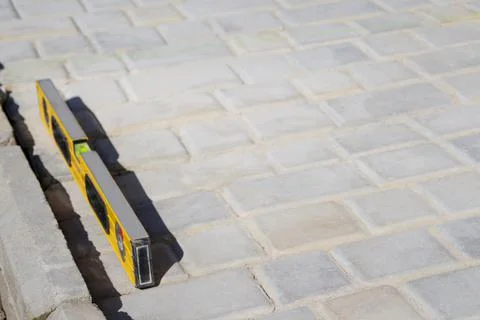 Defocus paving backyard patio background of stone floor texture. Yellow spiri Stock Photos