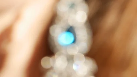 Defocus shiny earring with white and turquoise sparkles. Shiny diamonds close up Stock Footage 121506854
