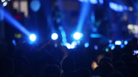 Defocus silhouettes of concert crowd in front of bright stage lights Stock Footage 67513952