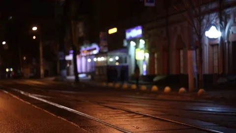 Defocus, soft focus. night city, city traffic, tram enters the frame Stock Footage 74374894