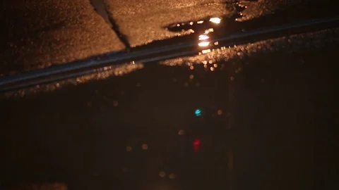 Defocus, soft focus. night city, city traffic, in a puddle on the asphalt reflec Stock Footage 74374921