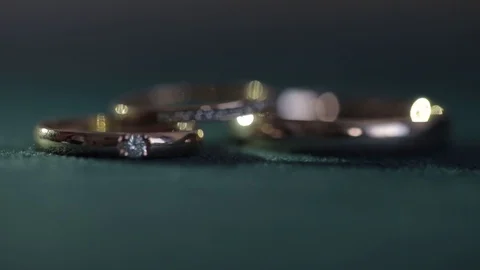 Defocus wedding rings on a dark green background Video stock 128604607
