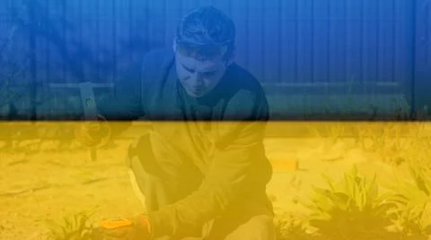 Defocus young construction worker in yellow glasses removing irregularities o Stock Photos