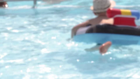 Defocused 4k real time kids are having fun in pool water Stock Footage 204858121