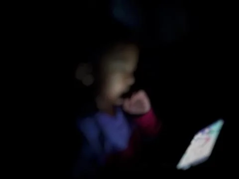 Defocused abstract background featuring a child engaged with a smartphone  Stock Photos