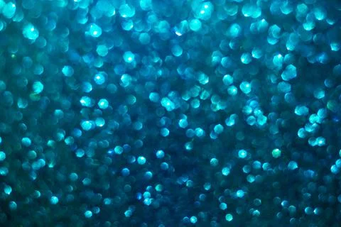 Defocused abstract background glittering with bright blue sparkles Stock Photos