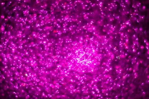 Defocused abstract background glittering with bright lilac sparkles. Stock Photos
