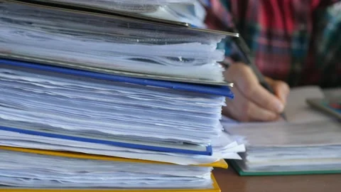 Defocused accountant working in office with documents, binders full of documents Видео 132006787