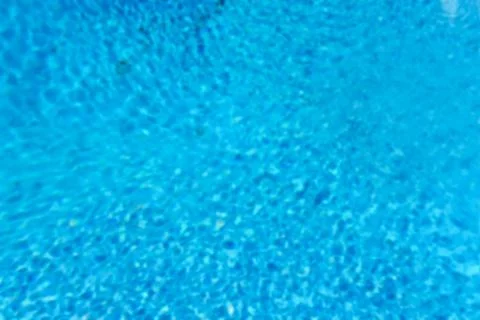 Defocused background with blue water surface of a swimming pool Stock Photos