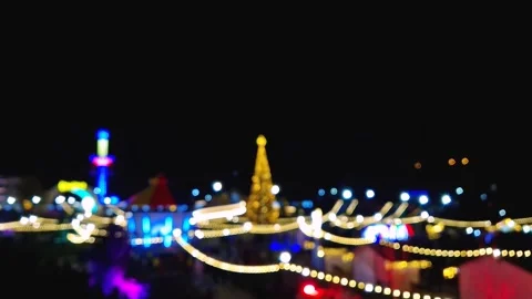 Defocused background with glittering bokeh lights of the Christmas fair at amuse Stock Footage 260303279