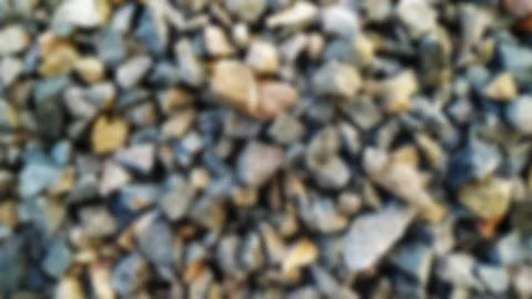 Defocused background of ground stone of many small stones. Stock Photos