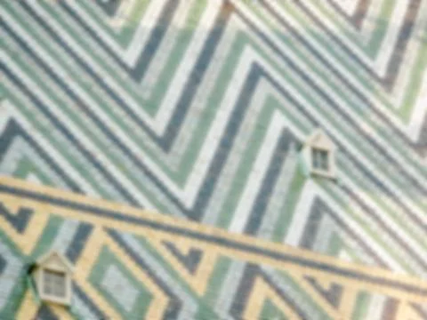 Defocused background of St Stephen's Cathedral roof in Vienna, Austria. Inten Stock Photos