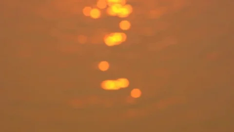 Defocused of beautiful warm sunset reflections on water surface Stock Footage 79435333