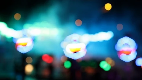 Defocused blinking colorful lights of a carousel at night Stock Footage 120138442
