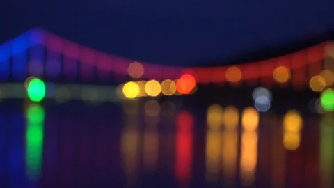 Defocused Blinking lights on night bridge, sparkle in water reflection Stock Footage 93699010